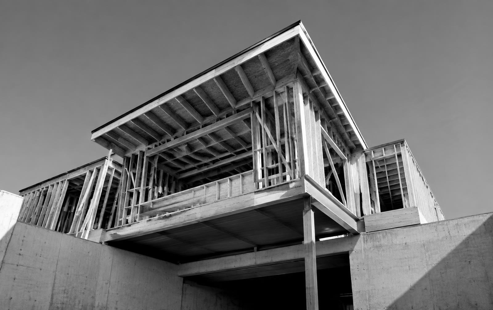 Building under construction with framing on a concrete base